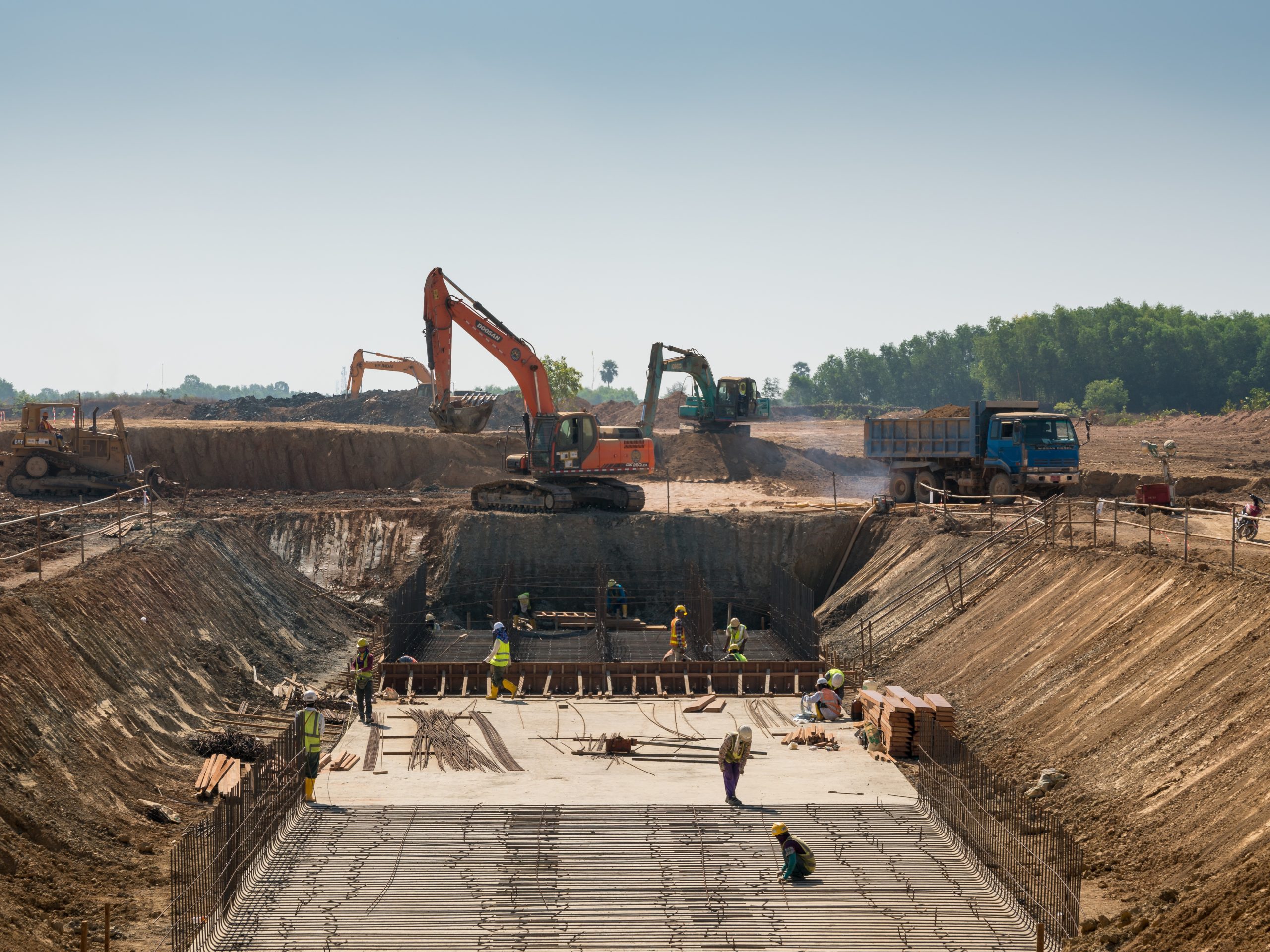 Construction professionals and heavy machinery on site